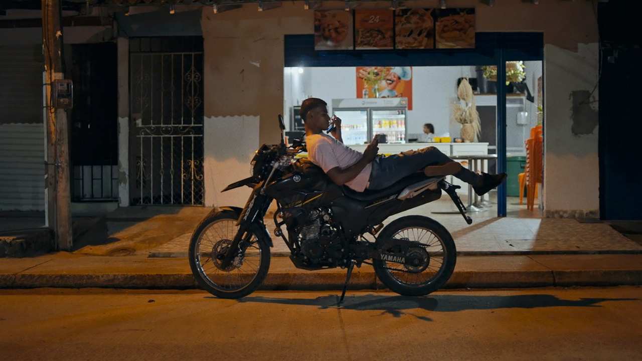 a man laying down on the back of a motorcycle
